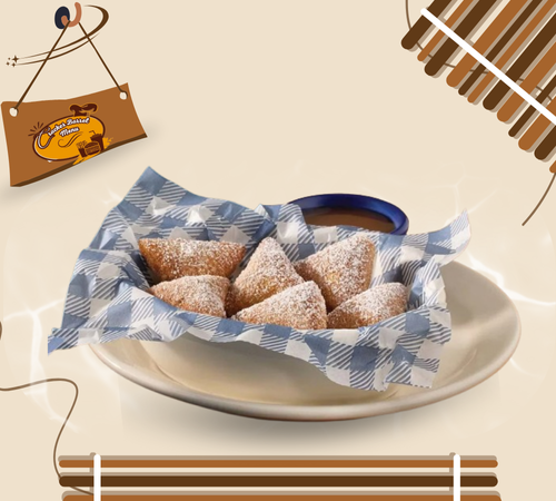 Fluffy biscuit beignets dusted with powdered sugar