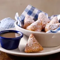 Sweet breakfast beignets with powdered sugar