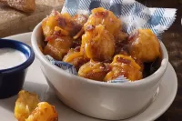 Loaded breakfast tots topped with cheesy goodness